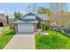 Charming home featuring a two-car garage, well-maintained lawn, and a delightful garden at 4734 S Garland St, Littleton, CO 80123