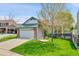 Inviting home showcasing a lush lawn, a two-car garage, and mature trees in a peaceful setting at 4734 S Garland St, Littleton, CO 80123