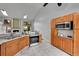 Kitchen featuring stainless steel appliances and classic cabinets with bright tile floors at 4734 S Garland St, Littleton, CO 80123