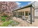 Back patio featuring stylish outdoor seating and dining areas in a blooming backyard at 6660 E Floyd Ave, Denver, CO 80224