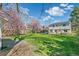 Expansive lawn with patio, garden and blossoming trees offering a private outdoor retreat at 6660 E Floyd Ave, Denver, CO 80224