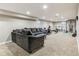 Finished basement with carpet, recessed lighting, a sectional, and exercise equipment at 6660 E Floyd Ave, Denver, CO 80224