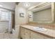Traditional bathroom with neutral tile, framed mirror and shower/tub combo at 6660 E Floyd Ave, Denver, CO 80224