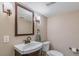 Updated bathroom with granite vanity and wood framed mirror at 6660 E Floyd Ave, Denver, CO 80224