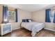Serene bedroom with hardwood floors, neutral walls, and ample natural light at 6660 E Floyd Ave, Denver, CO 80224