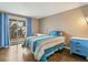 Cozy bedroom with hardwood floors, a balcony view, and a vibrant blue accent at 6660 E Floyd Ave, Denver, CO 80224
