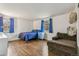 Comfortable bedroom with hardwood floors, natural light, and cozy decor at 6660 E Floyd Ave, Denver, CO 80224
