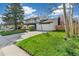 Two-story home with a well-maintained lawn, driveway, and attached garage under a partly cloudy sky at 6660 E Floyd Ave, Denver, CO 80224