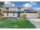 Charming two-story home with a front yard and a covered balcony providing inviting curb appeal at 6660 E Floyd Ave, Denver, CO 80224
