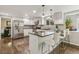Modern kitchen featuring stainless steel appliances, white cabinetry, and an island with bar seating at 6660 E Floyd Ave, Denver, CO 80224