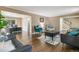 Cozy living room with hardwood floors, comfortable seating, and an adjacent office space at 6660 E Floyd Ave, Denver, CO 80224