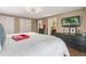 Spacious main bedroom featuring hardwood floors, a TV, and plenty of closet space at 6660 E Floyd Ave, Denver, CO 80224