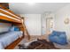 Bedroom with bunk beds, a cozy chair and an adjacent bathroom at 15050 Harrison St, Brighton, CO 80602