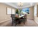 Bright dining room with wood table and chairs, offering a view of the backyard at 15050 Harrison St, Brighton, CO 80602