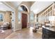 Elegant entryway with tiled floors, staircase, and views to living room at 15050 Harrison St, Brighton, CO 80602
