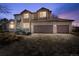 Two-story home with a three-car garage at dusk at 15050 Harrison St, Brighton, CO 80602