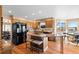 Kitchen features granite island, wood cabinets, and stainless steel appliances at 15050 Harrison St, Brighton, CO 80602