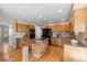 Open kitchen with granite island, stainless steel appliances, and wood cabinets at 15050 Harrison St, Brighton, CO 80602