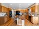 Bright kitchen with granite island, hardwood floors, and lots of cabinet space at 15050 Harrison St, Brighton, CO 80602