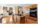 Kitchen with granite island, stainless steel appliances, and a view to the living area at 15050 Harrison St, Brighton, CO 80602