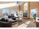 Sunlit living room with a cozy sectional sofa and a fireplace at 15050 Harrison St, Brighton, CO 80602