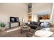 Open living room with a sectional sofa, fireplace and views to kitchen at 15050 Harrison St, Brighton, CO 80602