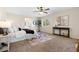 Main bedroom with a king-size bed, ceiling fan, and sitting area at 15050 Harrison St, Brighton, CO 80602