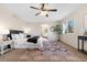 Main bedroom with king bed, ceiling fan and large window at 15050 Harrison St, Brighton, CO 80602