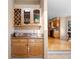 Built-in wet bar with wood cabinetry and granite countertop at 15050 Harrison St, Brighton, CO 80602