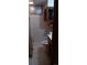 Tight bathroom with white tiled walls, toilet, and sink with mirror at 2008 Moline St, Aurora, CO 80010