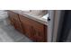 Wood bathroom vanity with detailed cabinets, tile backsplash and gray tile flooring at 2008 Moline St, Aurora, CO 80010