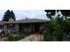 Charming home with brick exterior, mature trees, and covered front porch and driveway at 2008 Moline St, Aurora, CO 80010