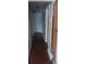 Hallway with dark wood floors, gray walls and white doorframes at 2008 Moline St, Aurora, CO 80010