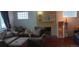 View of living room with brick fireplace and two couches at 2008 Moline St, Aurora, CO 80010