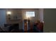 View of living room with brick fireplace and glass block window at 2008 Moline St, Aurora, CO 80010