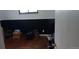 Open room with wood floor, black accent wall, and boxes at 2008 Moline St, Aurora, CO 80010