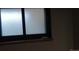 Window with privacy glass and tiled sill in neutral tones at 2008 Moline St, Aurora, CO 80010