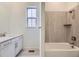Well-lit bathroom with tiled shower and bathtub, and a modern vanity sink at 15616 W Beloit Ave, Morrison, CO 80465