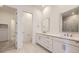 Bright bathroom featuring double vanity, modern fixtures, and tile flooring at 15616 W Beloit Ave, Morrison, CO 80465