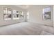 Bright bedroom with plush carpeting and lots of natural light from multiple windows at 15616 W Beloit Ave, Morrison, CO 80465