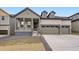 Charming home with covered porch, three-car garage, and modern architectural details at 15616 W Beloit Ave, Morrison, CO 80465