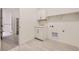 Bright laundry room with sink, storage cabinets, and washer/dryer hookups at 15616 W Beloit Ave, Morrison, CO 80465