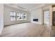 Bright living room with sleek fireplace and large windows offering beautiful views at 15616 W Beloit Ave, Morrison, CO 80465