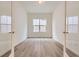 Bright office space with a large window and neutral decor, ideal for productivity at 15616 W Beloit Ave, Morrison, CO 80465