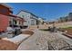 A backyard with concrete patio, decorative rock and mulch landscaping, and a dining area offers an inviting outdoor space at 4840 Point Mesa St, Castle Rock, CO 80108