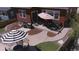 The backyard features a concrete patio, barbecue area, a dining area under a striped umbrella, and minimal maintenance landscaping at 4840 Point Mesa St, Castle Rock, CO 80108