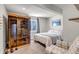 Comfortable bedroom with a sauna, plush carpeting, a queen sized bed, and a neutral color scheme at 4840 Point Mesa St, Castle Rock, CO 80108