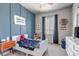 Charming bedroom with blue accent wall, soft carpet, and playful décor at 4840 Point Mesa St, Castle Rock, CO 80108