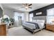 The primary bedroom features a neutral palette, a large window, and a stylish accent wall at 4840 Point Mesa St, Castle Rock, CO 80108
