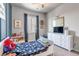 Comfortable bedroom with soft carpet, bright decor and a large window at 4840 Point Mesa St, Castle Rock, CO 80108